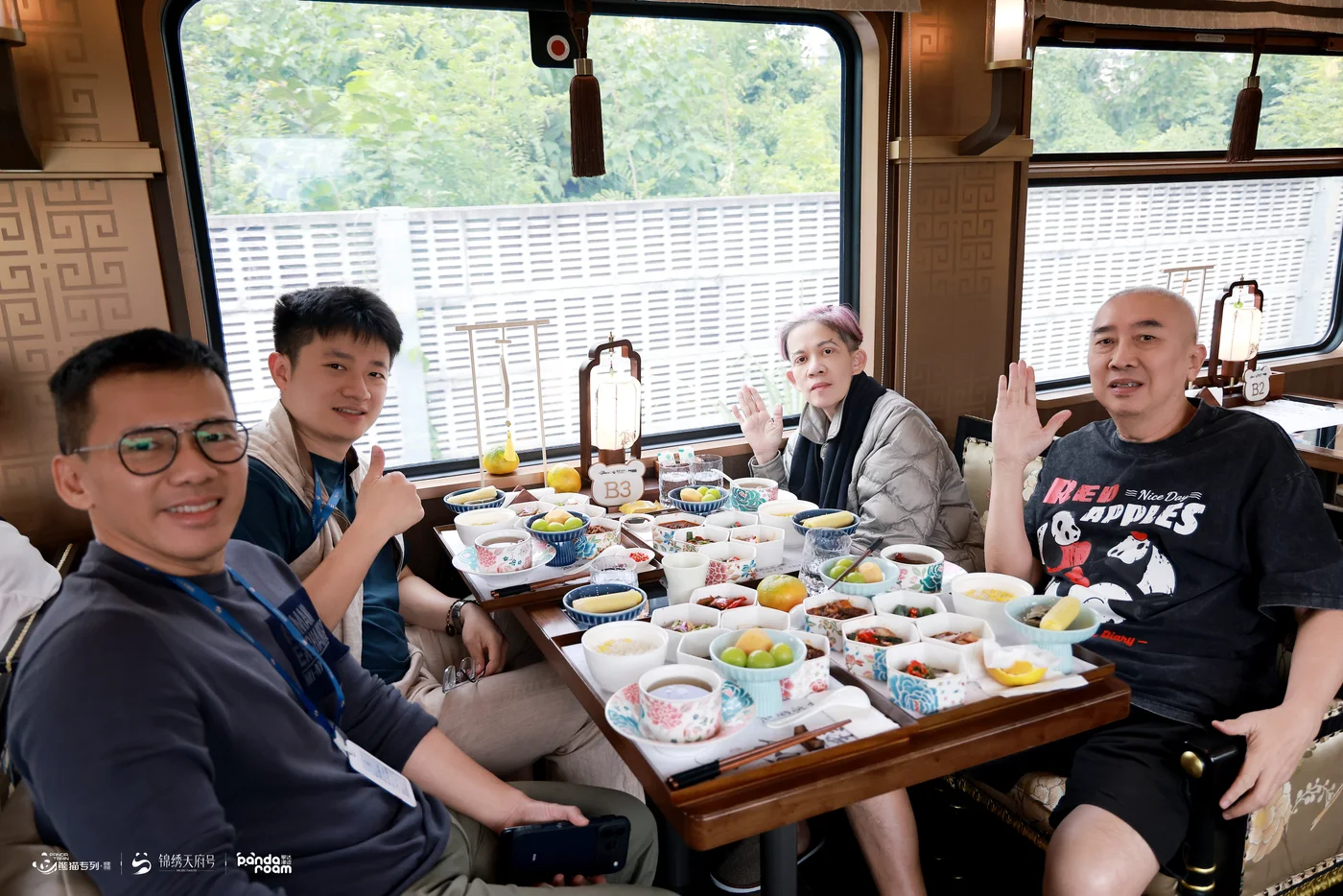 Travellers sharing a meal in the Jinxiu Tianfu dining carriage