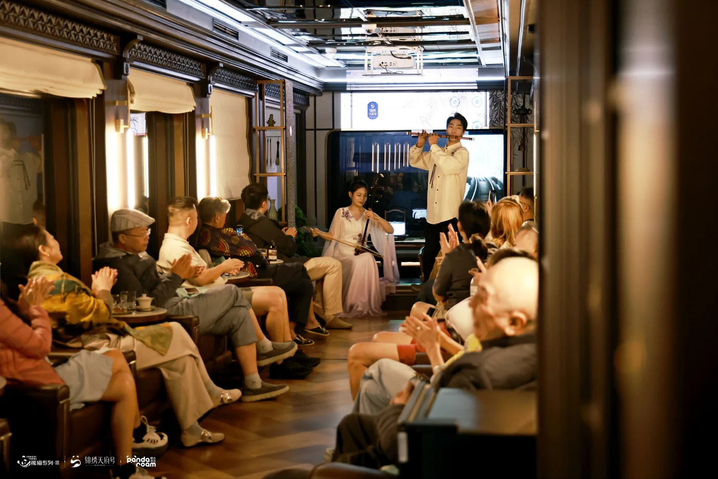 Passengers listening to flute and erhu performers aboard Jinxiu Tianfu