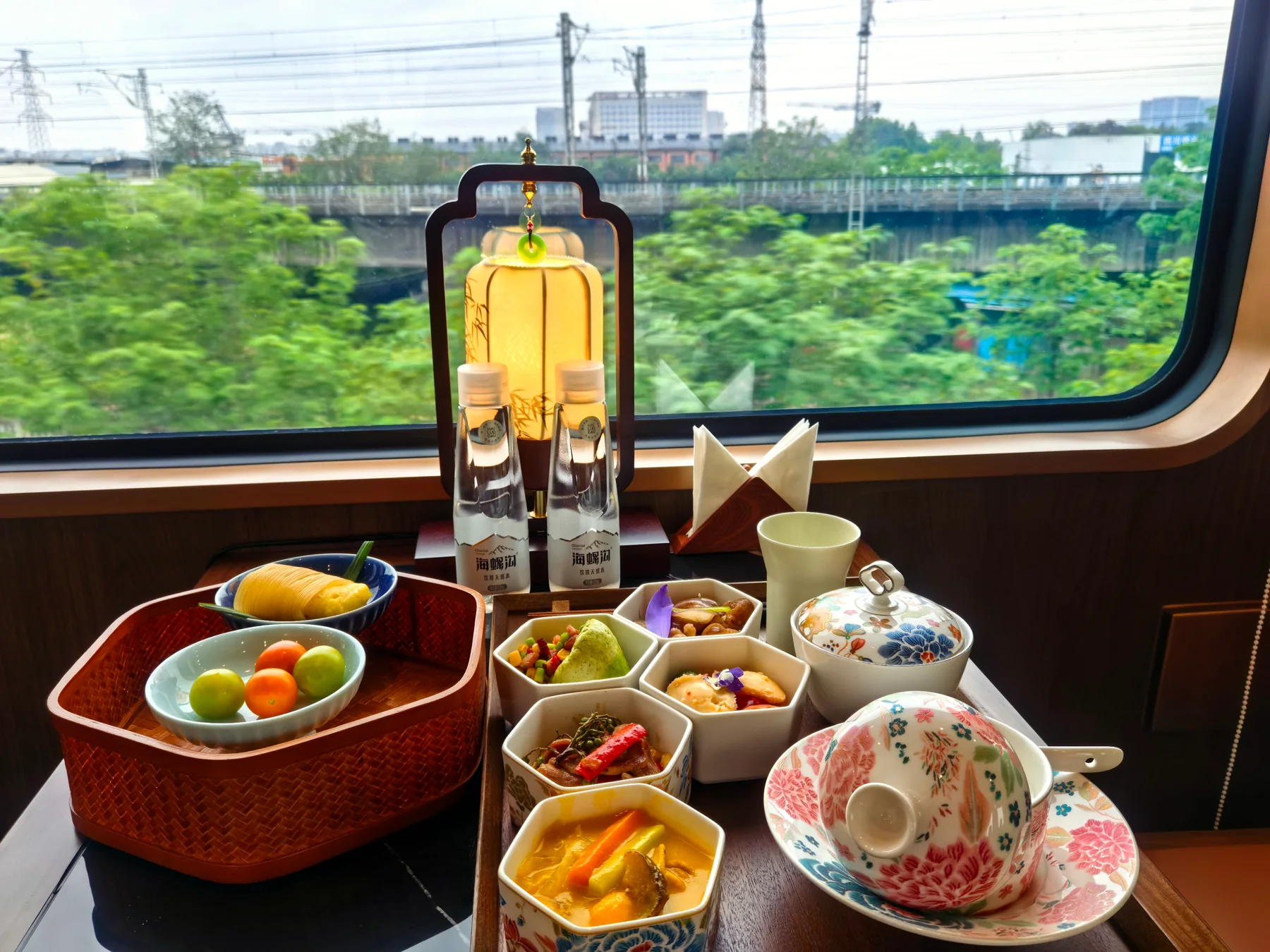 A meal arranged beside a train window